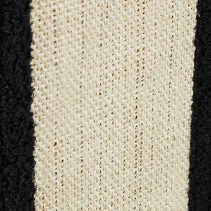 Black cat hide with scratching surface