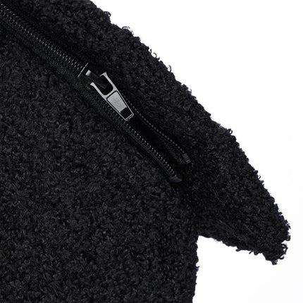 Black cat hide with scratching surface