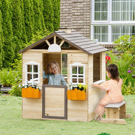 Wooden outdoor playhouse for children with flowers and mailbox