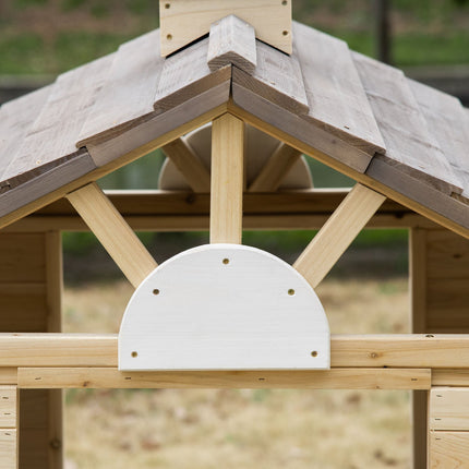 Wooden outdoor playhouse for children with flowers and mailbox