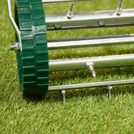 Rolling lawn aerator with handle